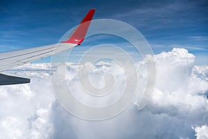 Airplane wing above the clouds photo