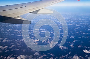 Airplane wing against the sky