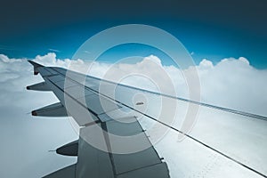 Airplane wing through the aircraft window. Greenhouse effect, global warming