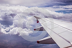 Airplane wing through the aircraft window. Greenhouse effect, global warming