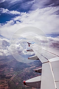 Airplane wing through the aircraft window. Greenhouse effect, global warming