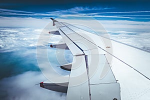 Airplane wing through the aircraft window. Greenhouse effect, global warming