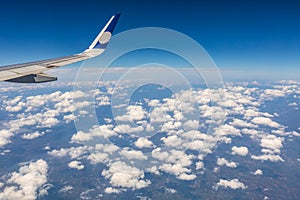 Airplane wing and beautiful blue sky with clouds