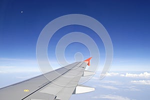 Airplane wing in the blue sky