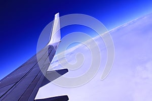 Airplane wing with blue sky in the background stock photo