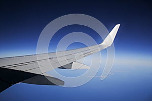 Airplane wing with blue sky