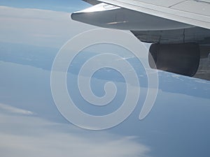 Airplane wing blue sky white clouds earth view