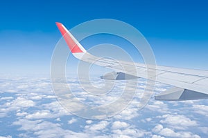 Airplane wing, Clouds and blue sky has seen through the window of an aircraft view