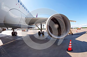 Airplane wing with engine, view under the plane during flight service