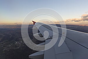 Airplane wing during the flight the early evening flight