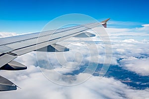 Airplane wing flying above the clouds