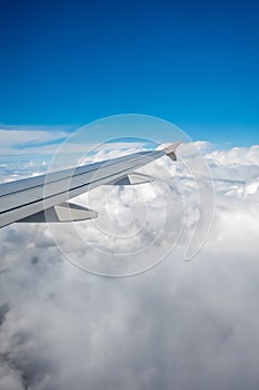 Airplane wing flying above the clouds