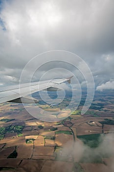 Airplane wing flying above the fields