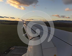 Airplane wing during the landing at the airport