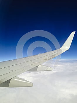 Airplane Wing in Midnight Blue Sky with Clouds