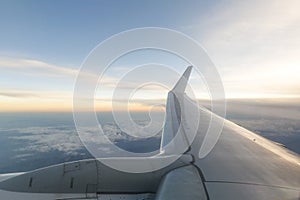 Airplane wing over the clouds during the flight