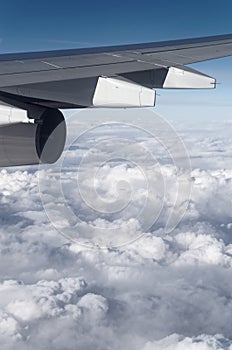 Airplane wing over cloudy sky
