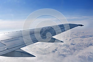 Airplane Wing Out of Window with Clouds and Sky