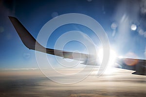 Airplane wing in the sunset flight to paradise