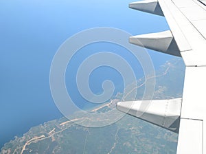 Airplane wing and view down to the ground.