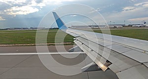 Airplane wing view out of the window on the cloudy sky The Earth