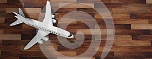 Airplane on wooden floor background, top view, copy space. 3d illustration