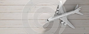 Airplane on wooden floor background, top view, copy space. 3d illustration