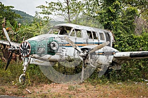 Airplane wreckage in jungle - old propeller aircraft in forest
