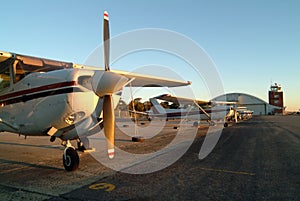 Airplanes lined up on the tarmac.