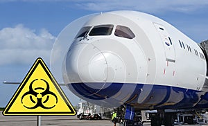 Airport. Bio-hazard sign in-front of airplane.