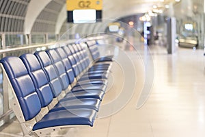 Airport blur background for air transportation travel concept with blurry bench seats for traveller or tourist on corridor