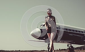 Airport and charming stewardess on blue airplane background. Portrait of charming stewardess wearing in blue uniform