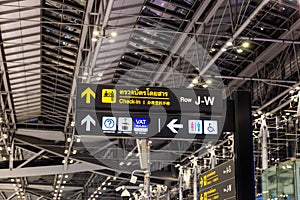 Airport check-in sign with restroom symbols, tax refund, information, etc. with directional arrows