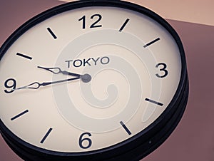 An airport clock showing Tokyo time zone