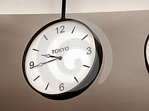 An airport clock showing Tokyo time zone