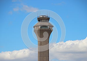 Airport Control Tower with Clouds and Blue Sky