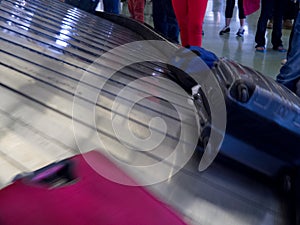 Airport conveyor belt baggage claim people waiting
