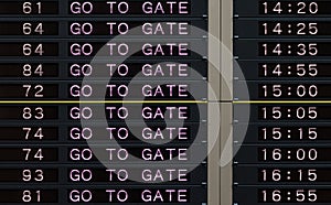 Airport departure board with go to gate sign