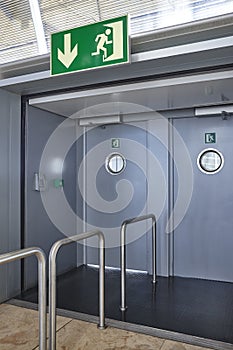 Airport emergency exit way out way metallic doors. Alert