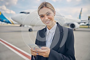 Airport employee holding a gadget in her hands