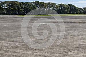 Airport field with greenery. Empty airstrip in tropical country. Summer vacation travel destination.