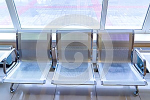 Airport gate waiting area with metal seats