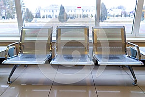 Airport gate waiting area with metal seats