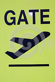 Airport Gate Yellow illuminated sign with gate number for departing flights pointing directions