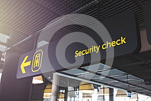 Airport informaction signs. Arrow on information screen leading to security check