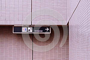 Airport information sign with direction to toilet, terminal entrance and restaurant