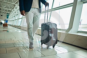 Airport legs, travel and man walking to airplane, flight booking or transportation for corporate trip. Luggage suitcase