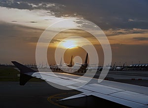 Airport with many airplanes at beautiful sunset, Aircraft fleet parked at taxiway