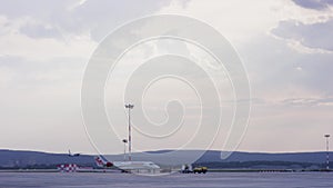 Airport, the plane on takeoff, landscape. Passengers airplane landing to airport runway in beautiful sunset light. White