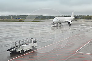 Airport runaway with airplane on a rainy day. Travel